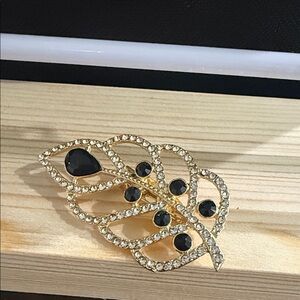 Elegant Gold and Black Leaf Brooch
